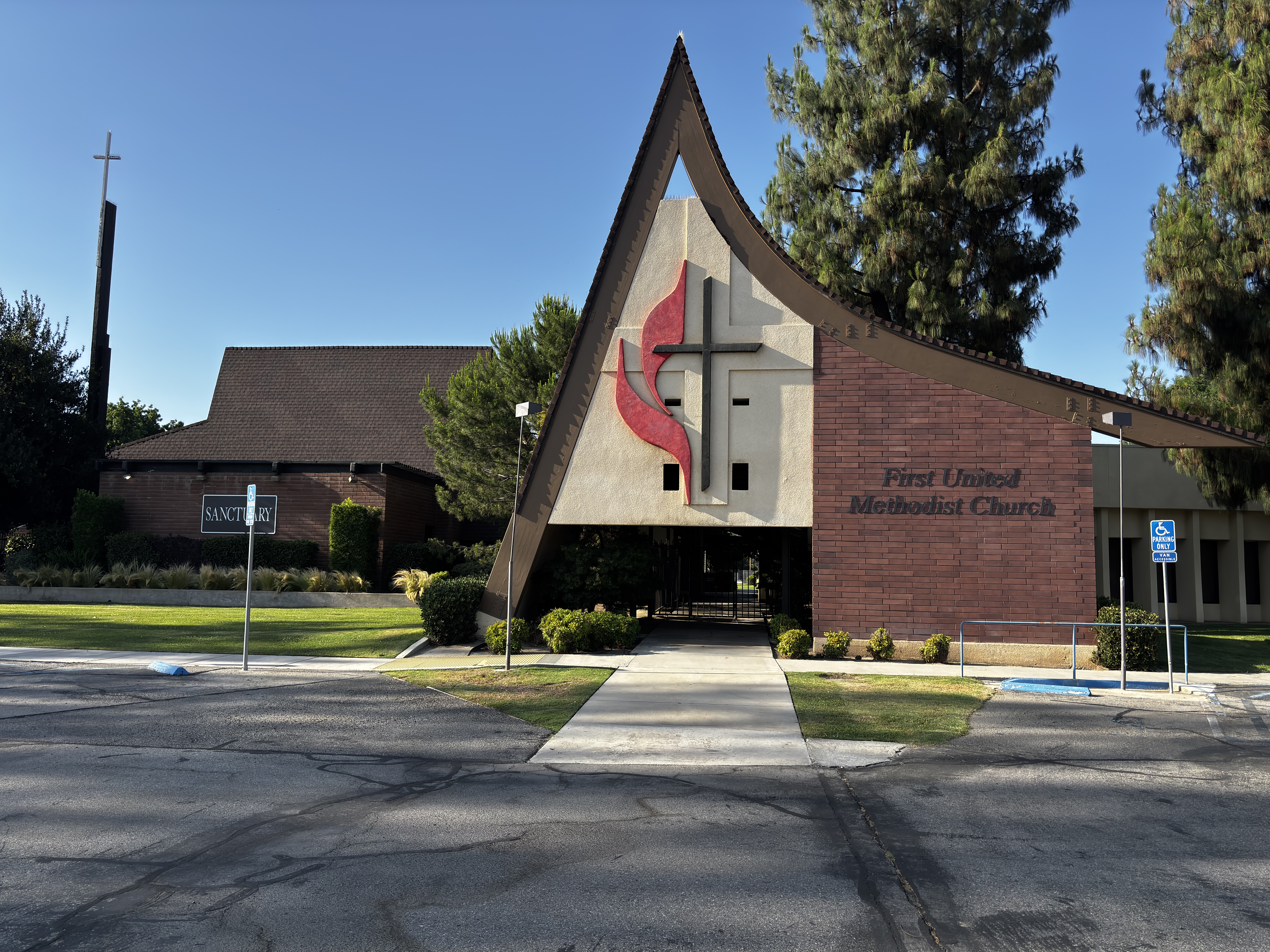 First United Methodist Church building with distinctive triangular architecture and cross