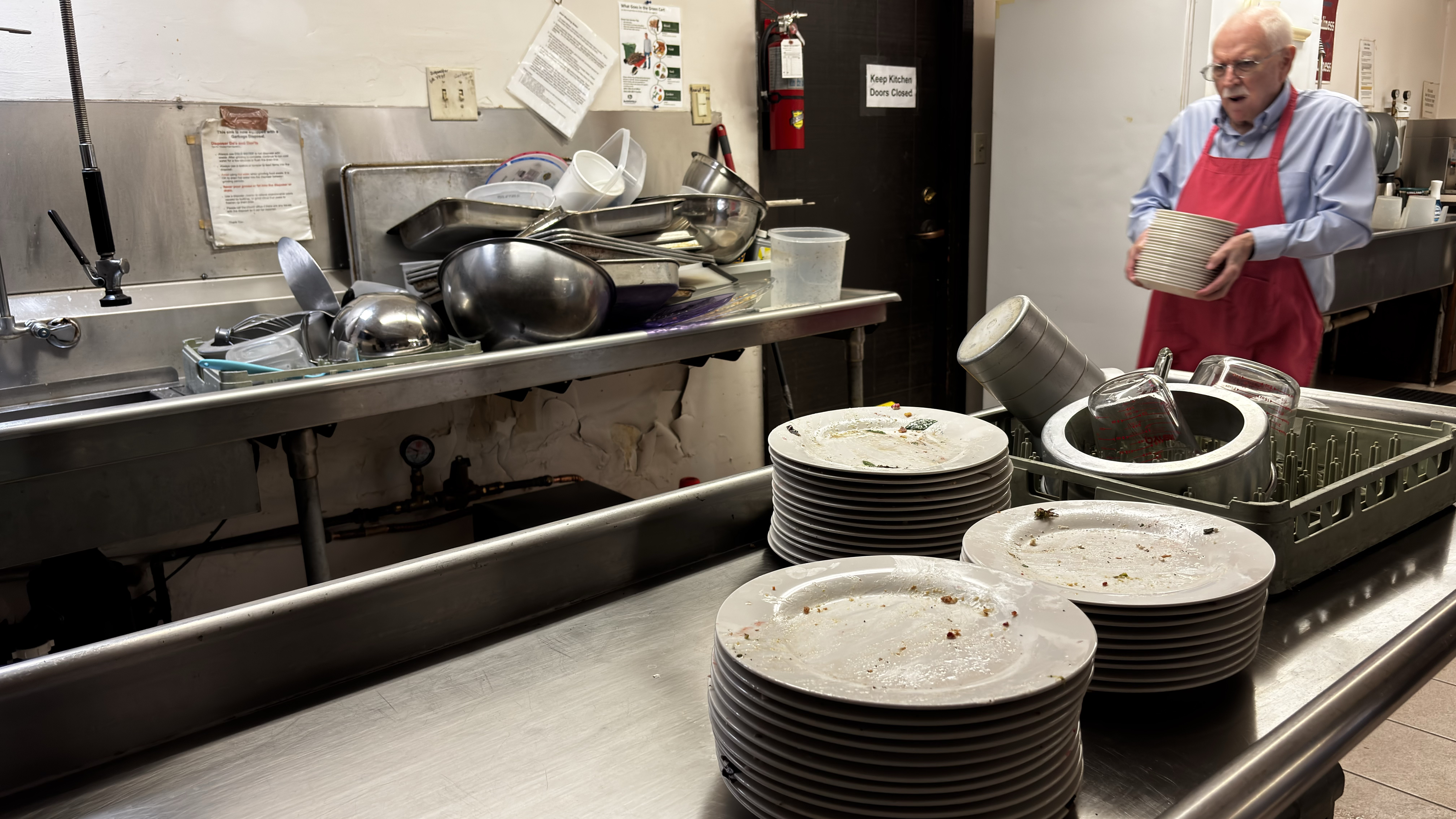 Male volunteer serving in kitchen
